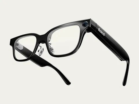 Rokid Glasses in black with clear lenses, showing the front camera and Rokid logo on the temple