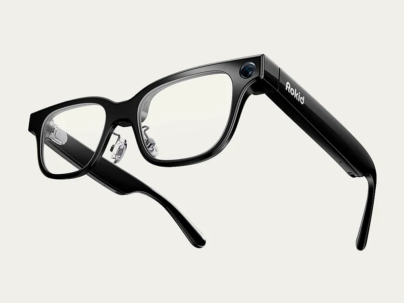 Rokid Glasses in black with clear lenses, showing the front camera and Rokid logo on the temple