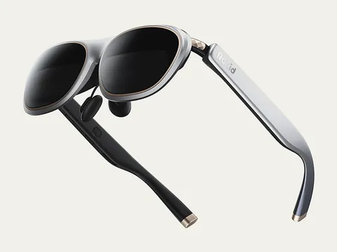 Rokid Max 2 display glasses in silver, three-quarter side view showing the dark birdbath lenses and black temple arms