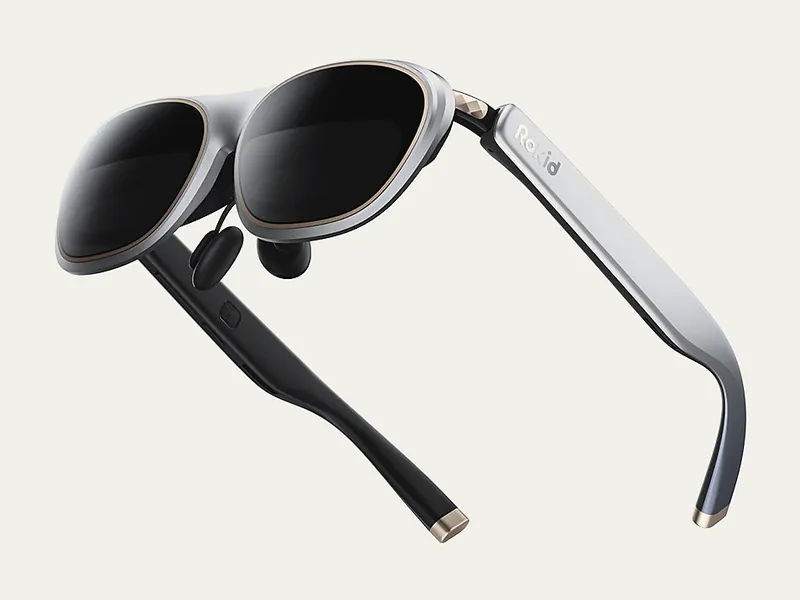 Rokid Max 2 display glasses in silver, three-quarter side view showing the dark birdbath lenses and black temple arms